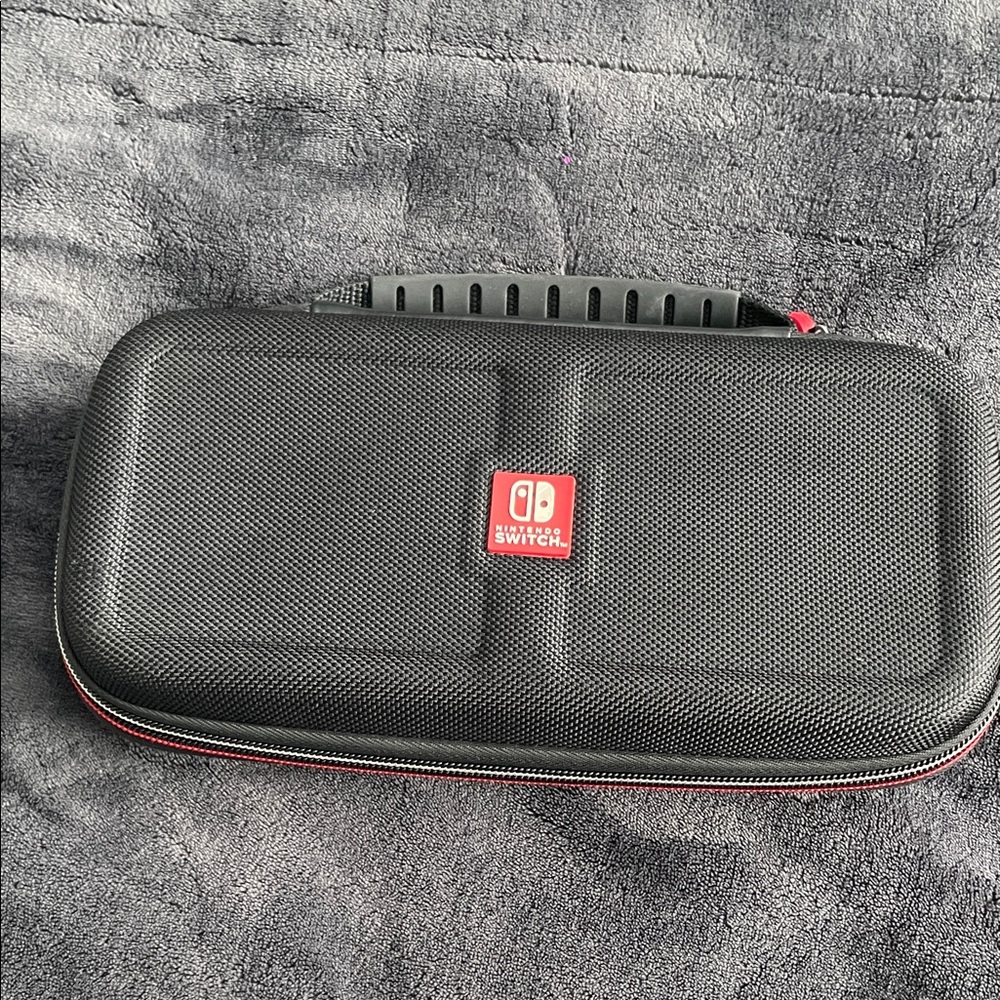 Nintendo Switch Black case with red and light grey accent stitching.